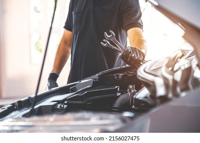 Close-up hand auto mechanic holding wrench to repairing car engine problem. Concepts of check and fix car and maintenance servicing. - Powered by Shutterstock