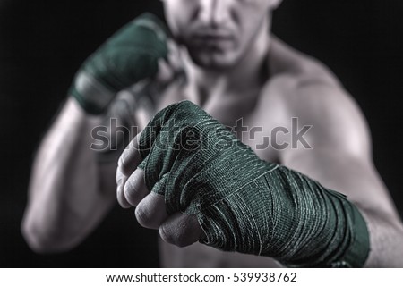 Close-up of hand of boxer ready for a fight. Concept. Strong arms and clenched fists