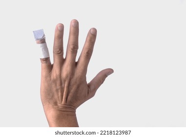 Closeup Hand With Broken Little Finger, Bandage On Finger On White Background