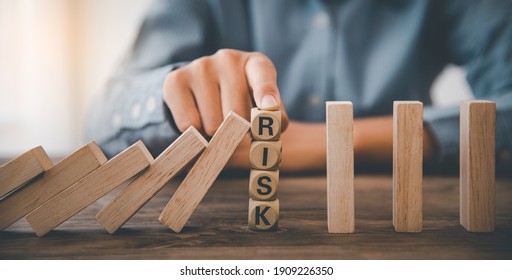 close-up hand The hand of a businessman who is stopping or preventing a falling block.Risk protection concept,Eliminating the risk - Shutterstock ID 1909226350