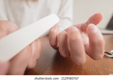 Close-up Of Hand Of Caucasian Young Woman Doing Manicure At Home With Nail Supplies.