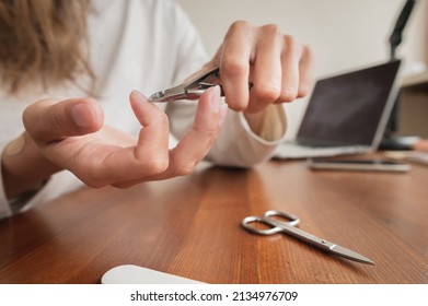 Close-up Of Hand Of Caucasian Young Woman Doing Manicure At Home With Nail Supplies.