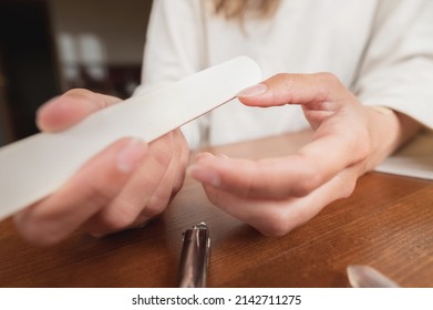 Close-up Of Hand Of Caucasian Young Woman Doing Manicure At Home With Nail Supplies.