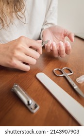 Close-up Of Hand Of Caucasian Young Woman Doing Manicure At Home With Nail Supplies.