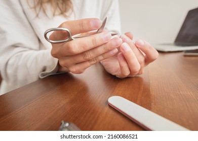 Close-up Of Hand Of Caucasian Young Woman Doing Manicure At Home With Nail Supplies.