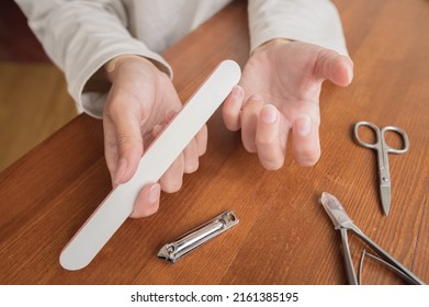 Close-up Of Hand Of Caucasian Young Woman Doing Manicure At Home With Nail Supplies.