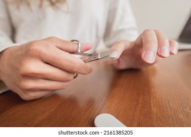 Close-up Of Hand Of Caucasian Young Woman Doing Manicure At Home With Nail Supplies.