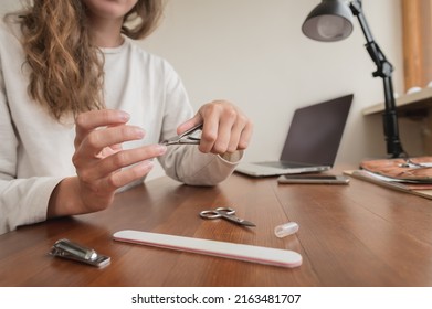 Close-up Of Hand Of Caucasian Young Woman Doing Manicure At Home With Nail Supplies.