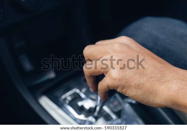 Closeup hand change\
gear while driving car