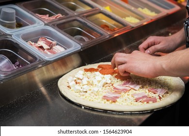 Closeup Hand Of Chef Baker Making Pizza At Kitchen Of Pizzeria