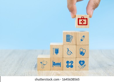Close-up hand choose cube shape wooden toy blocks stacked with medical equipment bag icon for health insurance concepts. - Shutterstock ID 1645638565