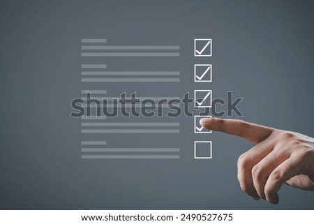 Close-up of hand completing a checklist with checkboxes on a dark background. Concept of task management, productivity, and organization.