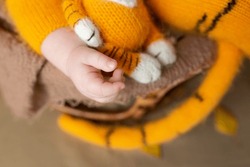 Close-up Of Hand With Cute Baby Toy, Tiger Costume, Lying In Bed, Innocence Concept
