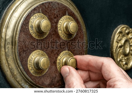 Close-up of hand dialing combination lock on a vintage safe.