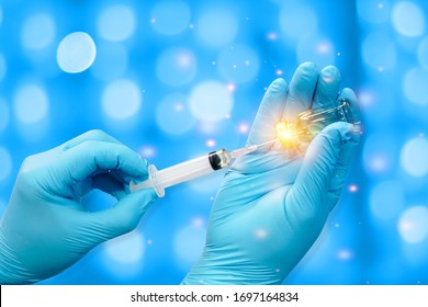 Closeup Hand Doctor or Scientists transparent medical gloves using syring Prepare a trial drug for the vaccine against Covid-19 on the world. Scientific and medical concepts - Shutterstock ID 1697164834