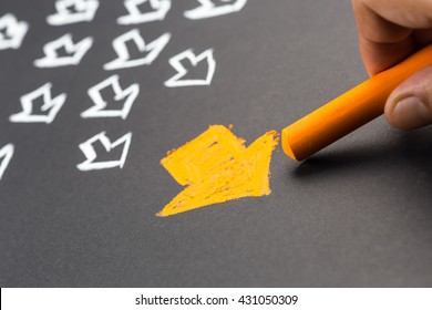 Closeup hand drawing orange arrow with many white arrows on background for trend leader or leadership concept - Shutterstock ID 431050309