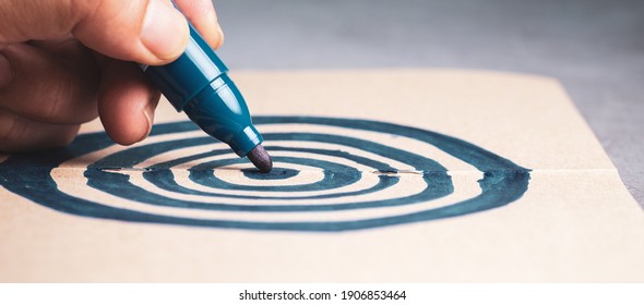 Closeup hand drawing target with pen on the notebook, concept for business marketing, goal, setting, career objective