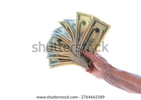 Close-up hand fanning out stack of twenty dollar bills against bright white background