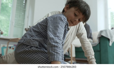 Close-up of a child’s hand and grandfather's hand while playing a matching game on the floor, focus on hands and game pieces, intergenerational bonding, family interaction, fun indoor activity - Powered by Shutterstock