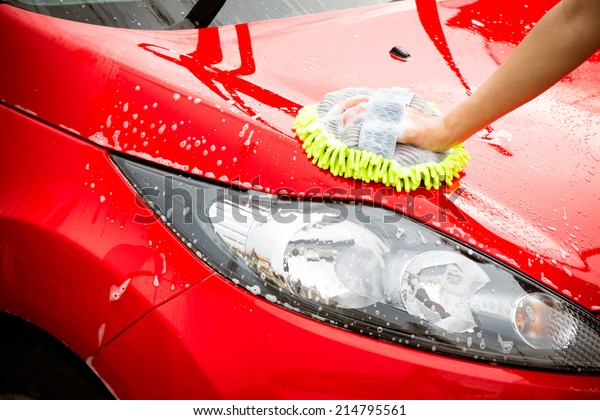 Close-up Of Hand\
With green Brush Washing Red\
Car