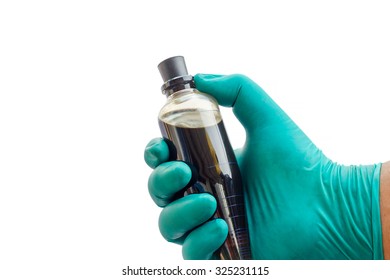 Close-up Hand Hold Glass Tube With Crude Oil On White Background