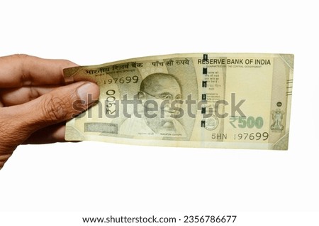Closeup of hand hold Indian currency 500 rupees bank note.