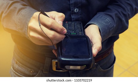 closeup of hand holding bar code scanner 
