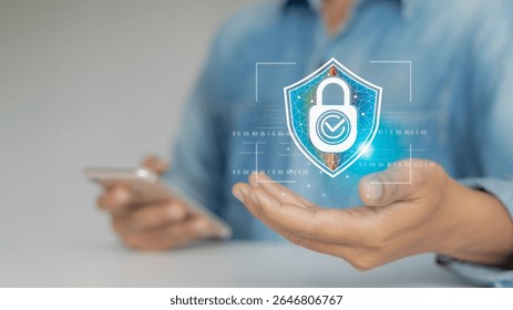 Close-up of hand holding a digital shield icon with lock, representing cybersecurity, data protection, and secure mobile access using smartphone.