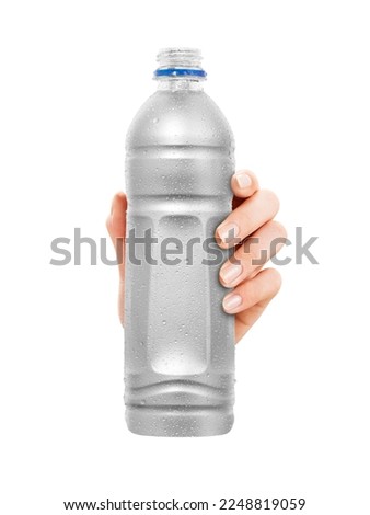 Close-up of hand holding Empty plastic Bottle with condensation. isolated on white Background. front view.