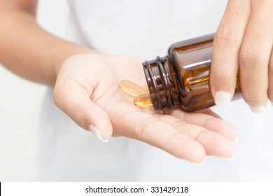 Closeup Hand Holding Fish Oil Vitamin For Healthy