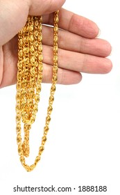 Close-up Hand Holding Gold Necklace.