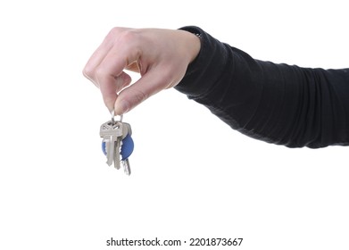 Close-up Of A Hand Holding House Keys Isolated On White Background