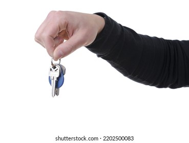 Close-up Of A Hand Holding House Keys Isolated On White Background