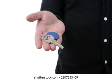 Close-up Of A Hand Holding House Keys Isolated On White Background