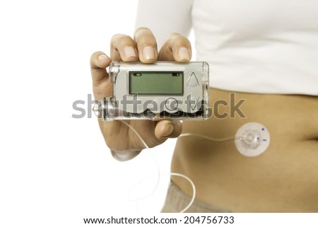 closeup of a hand holding an insulin pump isolated on a white background