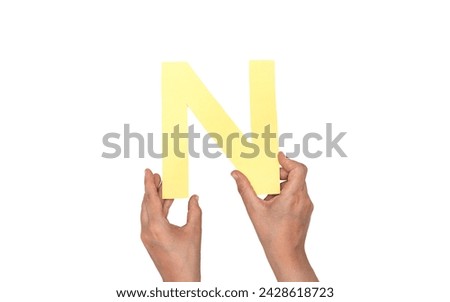 closeup hand holding paper letter N isolated on white Foto stock © 