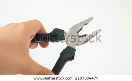 close-up of hand holding pliers on white background, repair tool