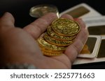 close-up hand holding real austrian golden coins. investments, savings, finances stock photo 