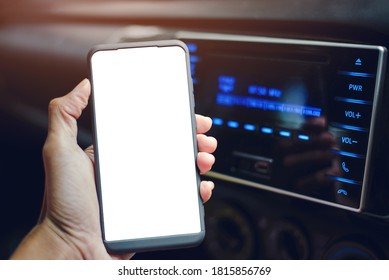 Closeup Hand Holding A Smartphone And The Bluetooth Is Connected, Playing Music In The Car.