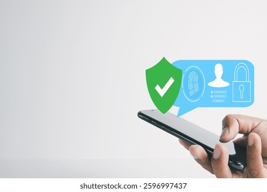 Close-up of a hand holding a smartphone with digital security icons, including a shield, fingerprint scan, and a padlock. Concept of mobile phone security, login protection,biometric authentication.