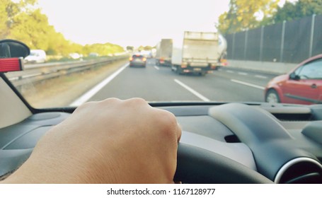 Closeup Of Hand Holding Steering Wheel During Driving A Car On Highway. POV Shot, Point Of View First Person Perspective.