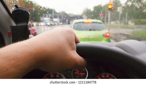 Closeup Of Hand Holding Steering Wheel During Driving A Car In Rainy Weather. POV Shot, Point Of View First Person Perspective.