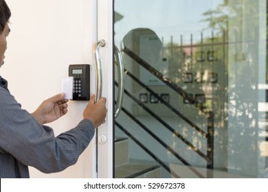 Close-up Hand Inserting Keycard To Lock And Unlock Door - Door Access Control Keypad With Keycard Reader