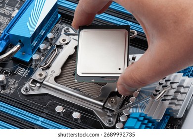 Close-up of a hand installing a CPU processor into a motherboard socket, representing computer technology, digital hardware, upgrade, and repair work.