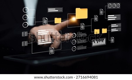 A close-up of a hand interacting with a digital interface that illustrates data management concepts, showcasing innovation and modern business strategies. Gantry
