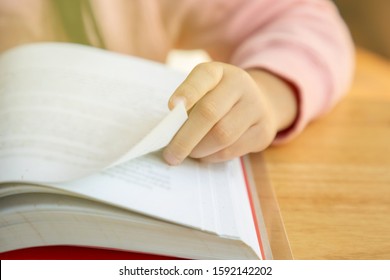 Closeup hand of kid  while reading a book