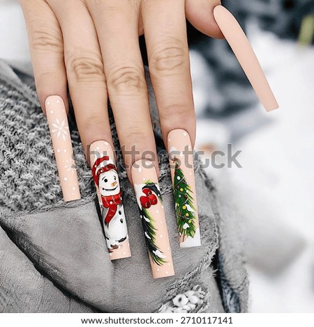 Close-up of a model’s hand with long square nails featuring snowman art designs. Christmas manicure. Snowman Nail Art, Long Square Nails, Winter Nail Design
