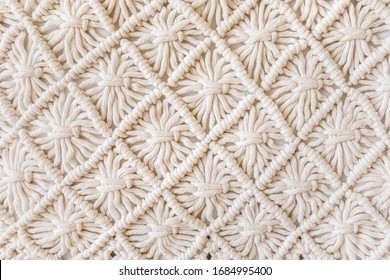 Close-up of hand made macrame texture pattern. ECO friendly modern knitting DIY natural decoration concept. Flat lay.