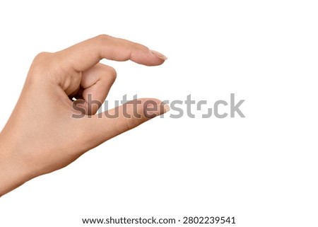 Close-up of a hand making a snapping or picking motion on a white background