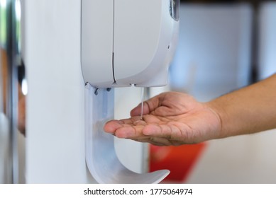 close-up hand male under automatic alcohol gel dispenser for cleaning hand and clear bacteria for stop Covid 19 virus outbreak. Protection against the virus, Covid-19, corona virus 2019 - Shutterstock ID 1775064974